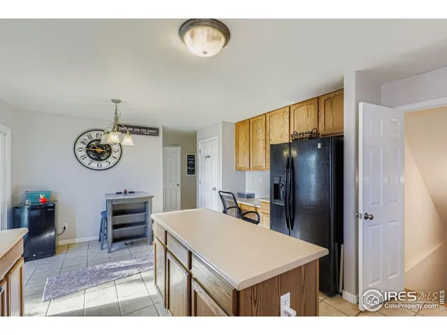 a kitchen with stainless steel appliances a table chairs and refrigerator