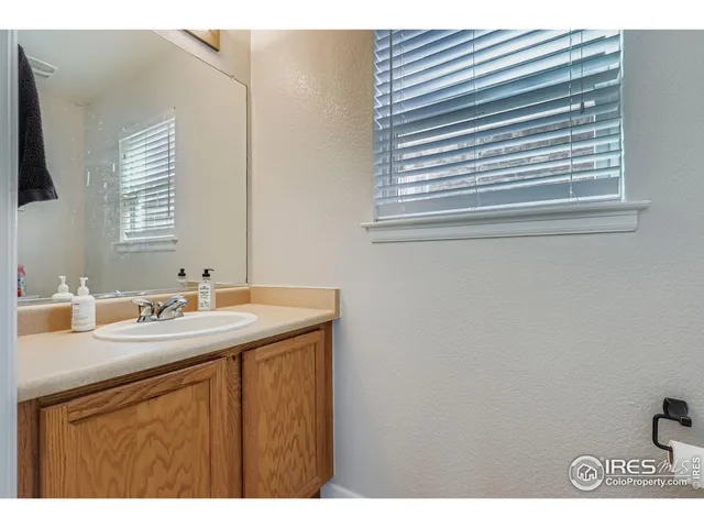 a kitchen with a sink cabinets and a window