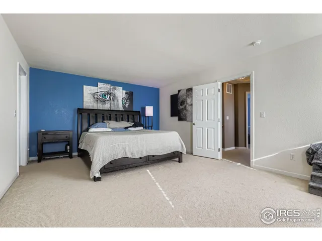 a bedroom with a bed and a view of kitchen