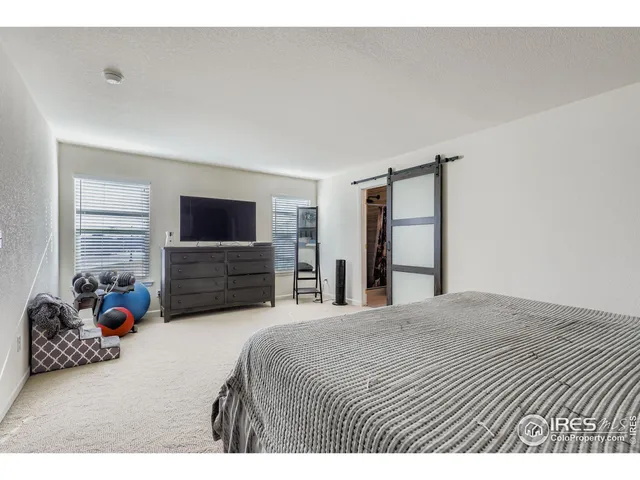 a bedroom with a bed and a television