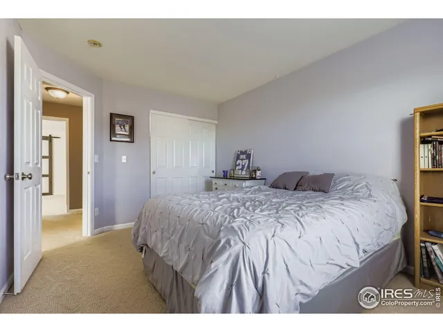 a bedroom with a bed and a lamp