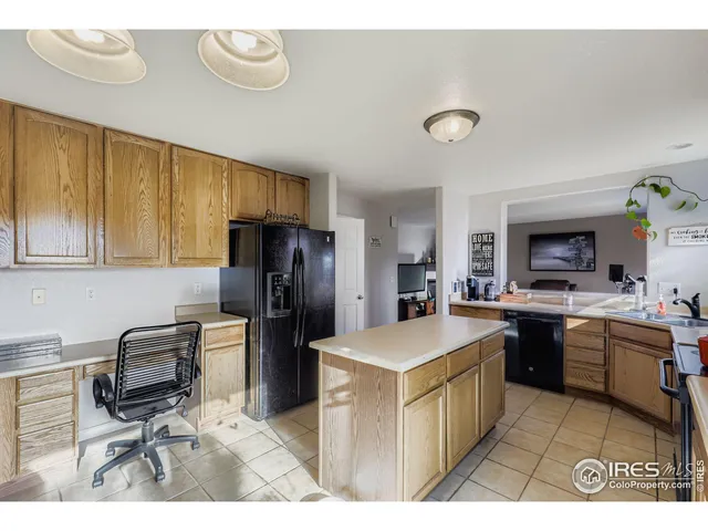 a kitchen with refrigerator cabinets and wooden floor
