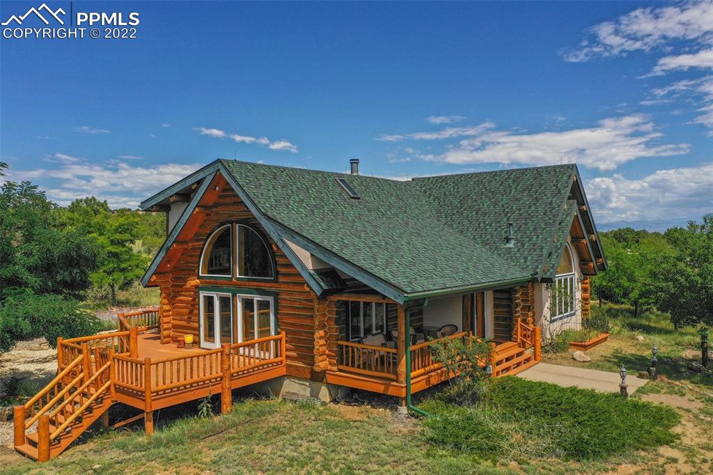 an aerial view of a house with a yard
