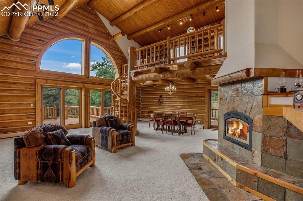 3311 County Road 103 Florence, CO 81226 - Photo 17 of 50 a living room with furniture a fireplace a flat screen tv and windows