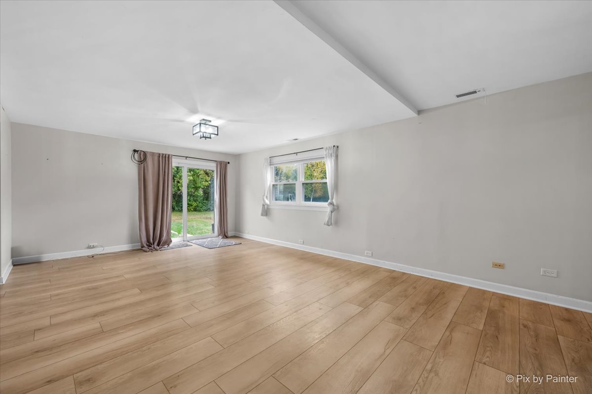9520 Stacy Lane Union, IL 60180 - Photo 13 of 45 a view of an empty room with wooden floor and a window
