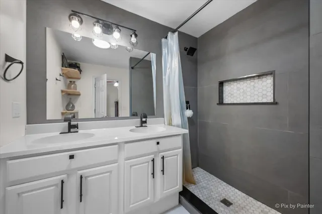 a bathroom with a double vanity sink and a mirror