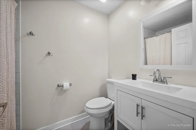 a bathroom with a sink toilet and a mirror