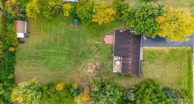 an aerial view of a house with a yard