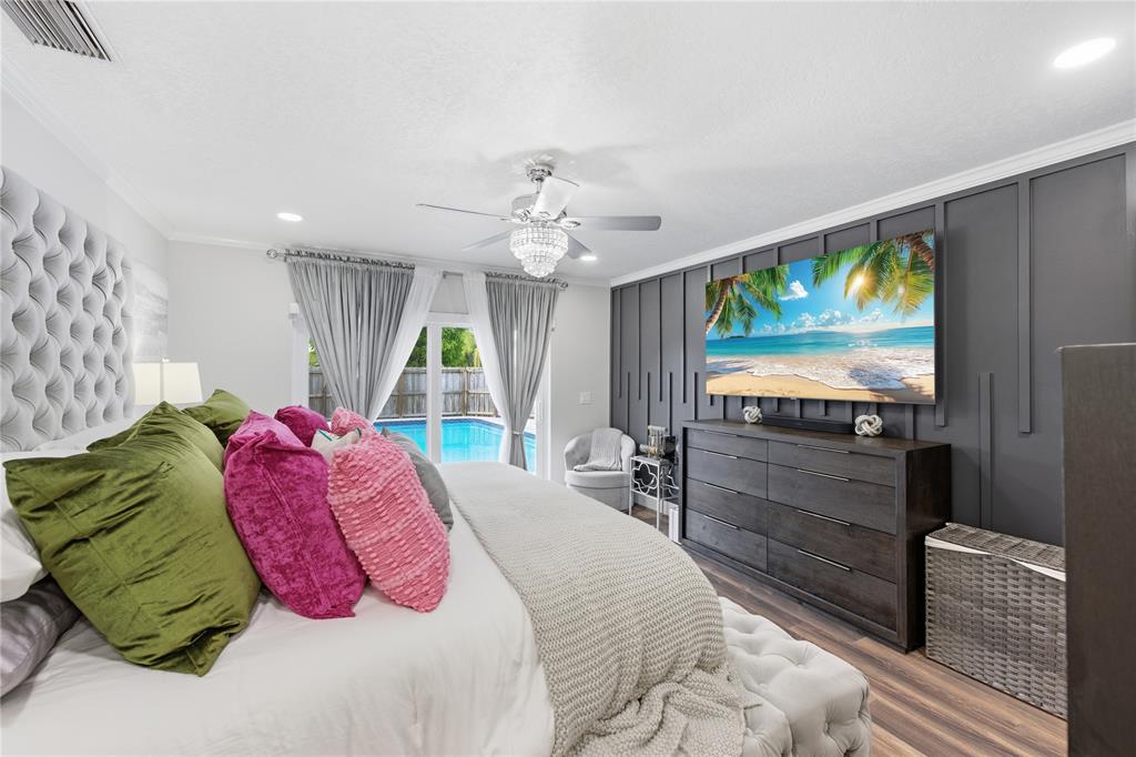 23367 Boca Trace Drive Boca Raton, FL 33433 - Photo 15 of 34 a bedroom with a bed and a flat screen tv