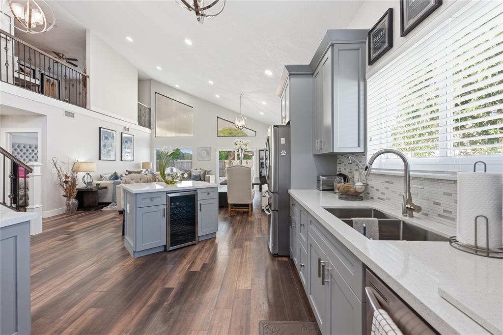 23367 Boca Trace Drive Boca Raton, FL 33433 - Photo 9 of 34 a kitchen with stainless steel appliances kitchen island granite countertop a sink stove and cabinets