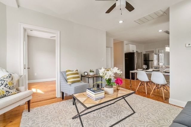 a living room with furniture and kitchen view