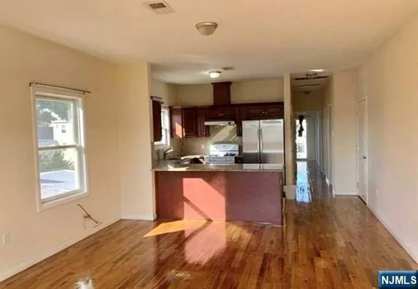 a kitchen with kitchen island granite countertop wooden cabinets and counter space