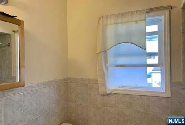 an empty room with windows and cabinet