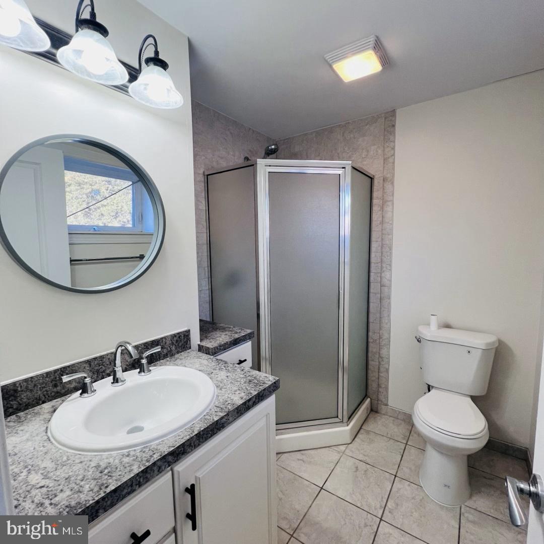 619 South 42nd Street Philadelphia, PA 19104 - Photo 20 of 25 a bathroom with a granite countertop sink toilet and a mirror