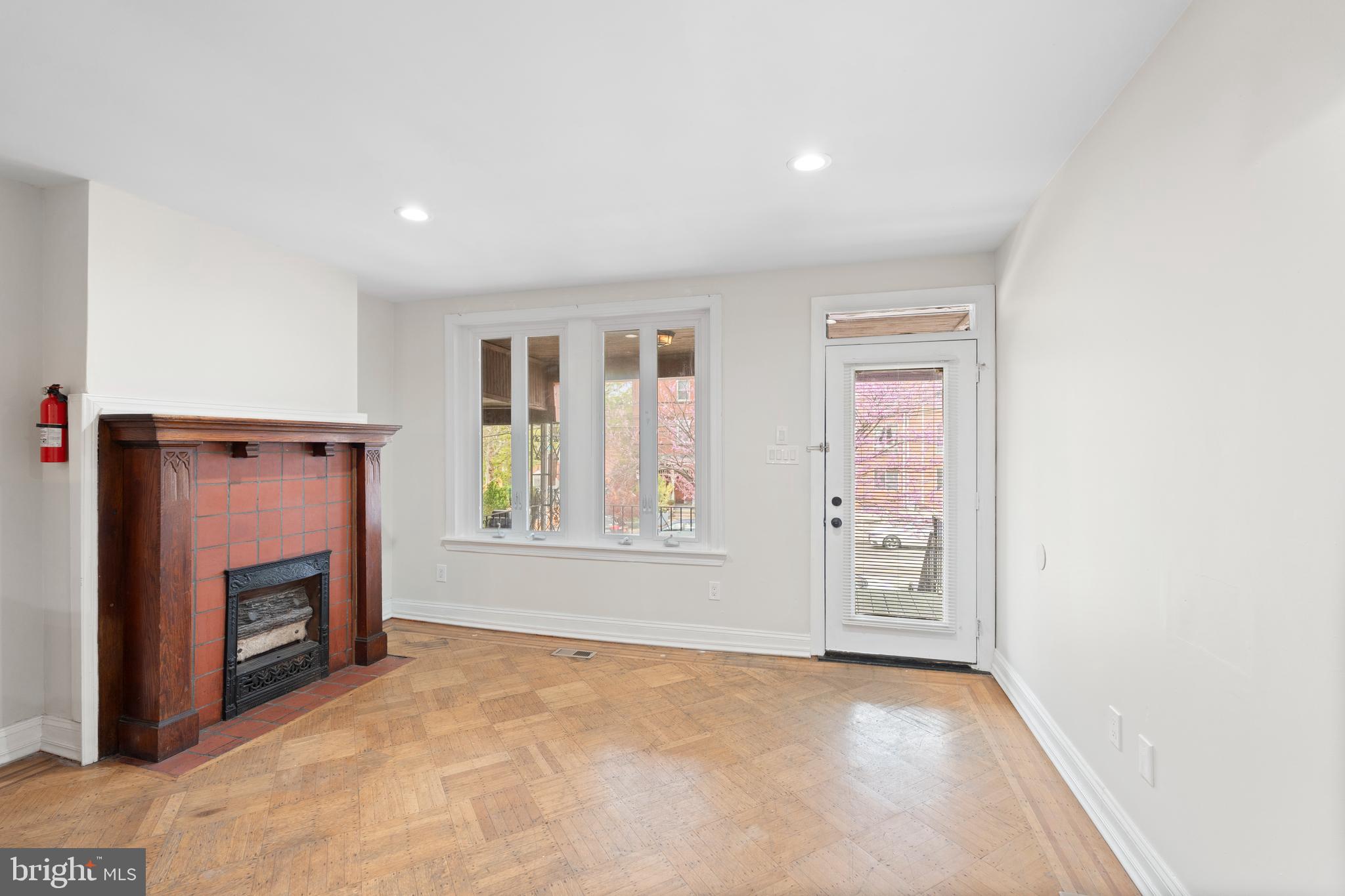 619 South 42nd Street Philadelphia, PA 19104 - Photo 4 of 30 an empty room with windows and fireplace
