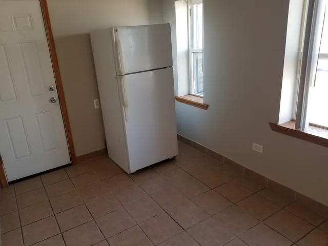 a view of a room with wooden floor and a window