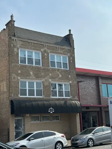 a front view of a building with parking space
