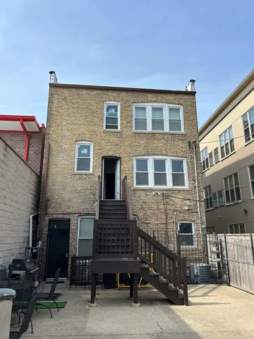 a brick building with a bench in front of it