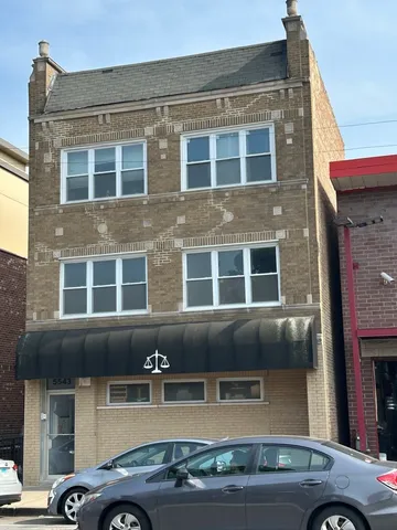 a front view of a building with parking space