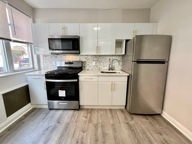 a kitchen with a refrigerator sink and microwave
