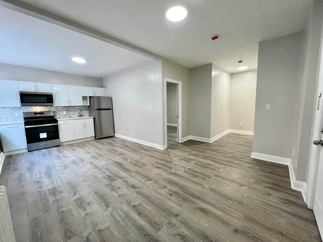 a view of a kitchen with a sink and a refrigerator