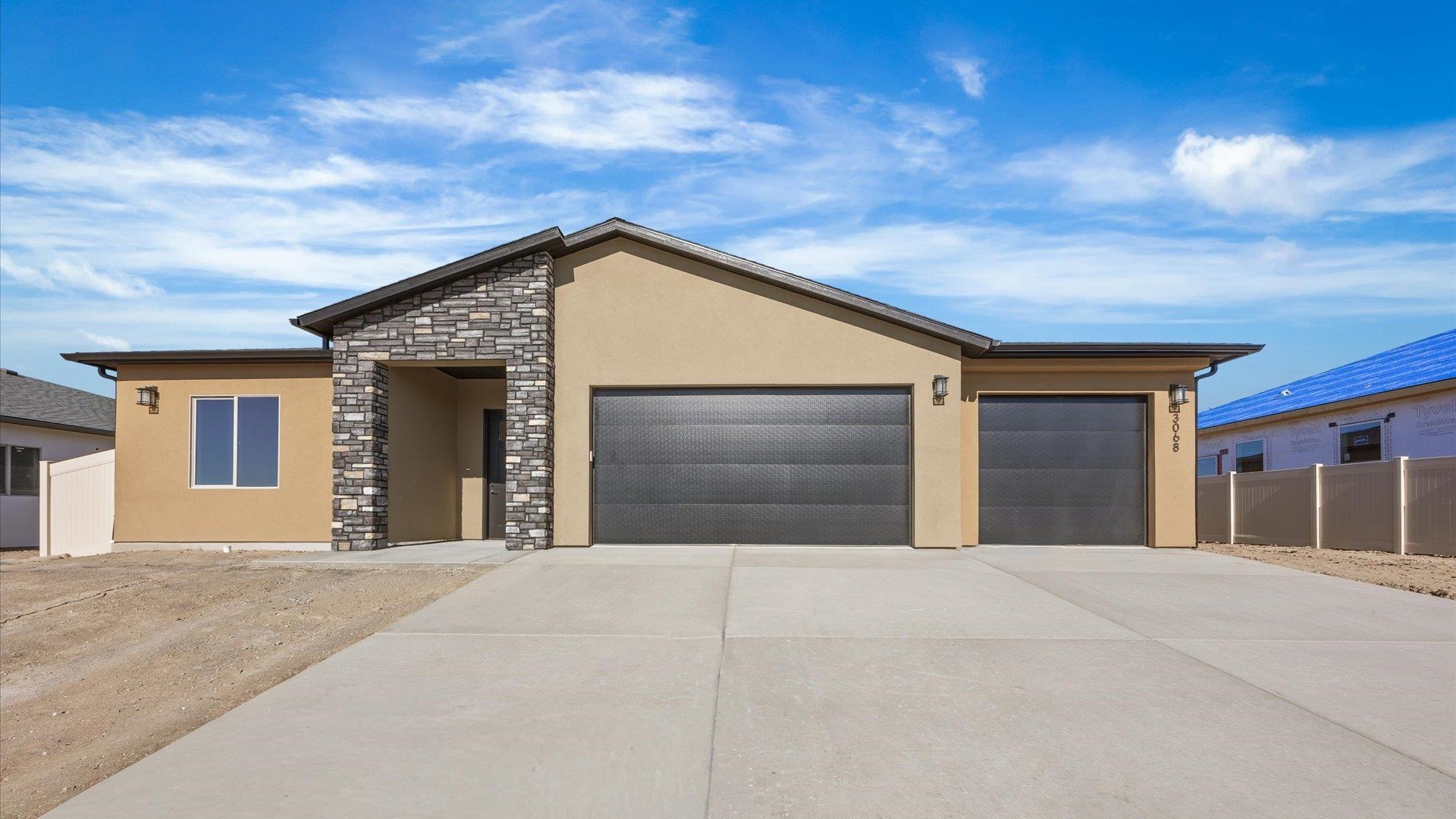 3068 Thunderhead Way Grand Junction, CO 81504 - Photo 1 of 7 a view of a house with a garage