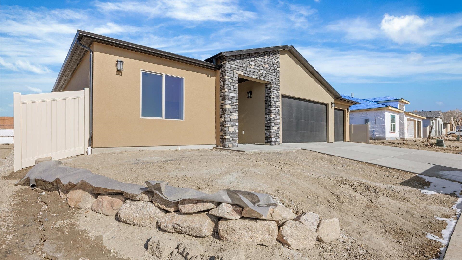 3068 Thunderhead Way Grand Junction, CO 81504 - Photo 3 of 7 a front view of a house with a yard