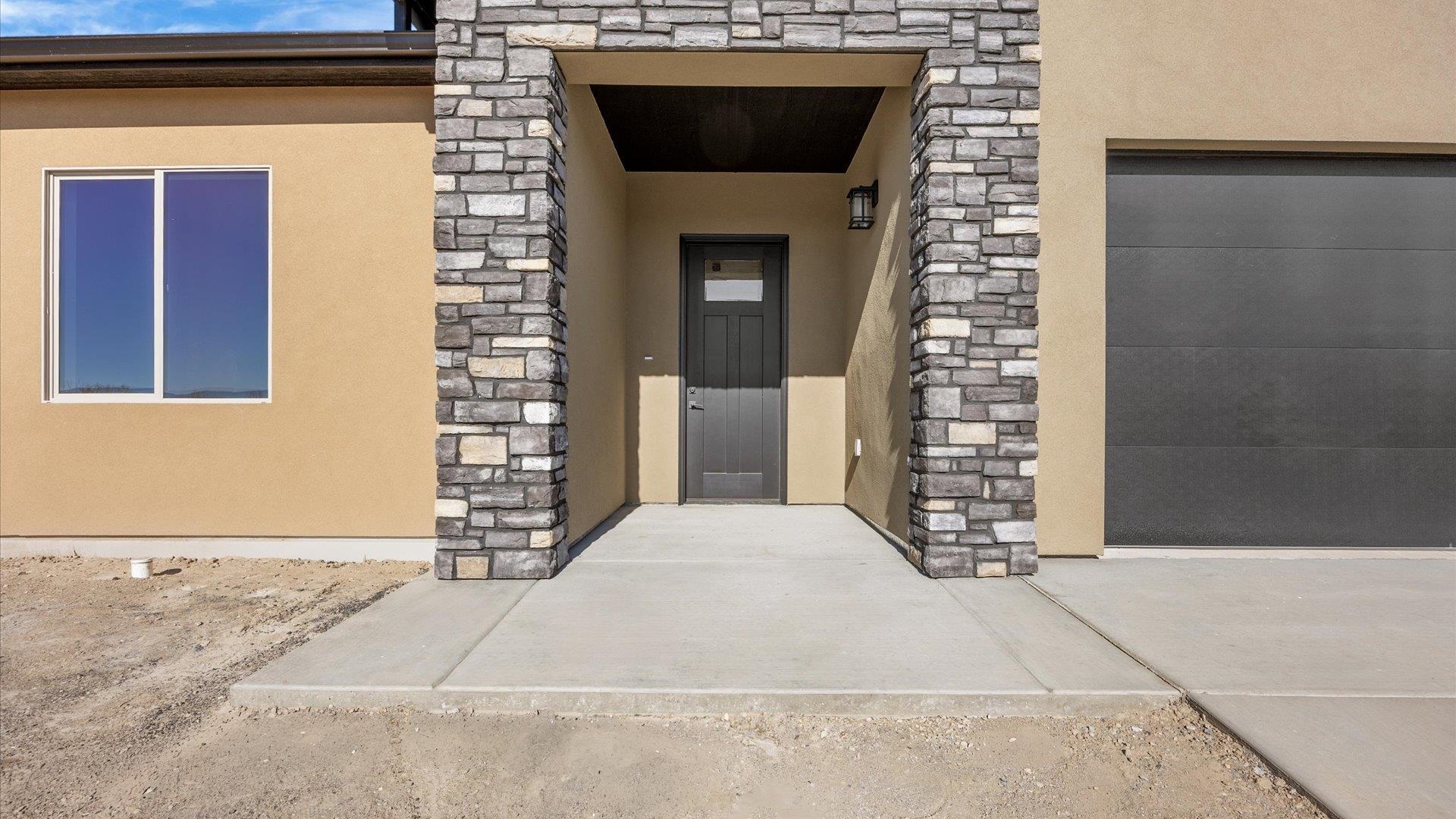 3068 Thunderhead Way Grand Junction, CO 81504 - Photo 6 of 7 a front view of a house with a yard