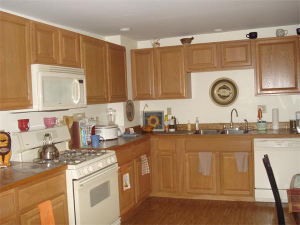 21 12th Street Wareham, MA 02558 - Photo 8 of 9 a kitchen with granite countertop a stove a sink dishwasher and cabinets with wooden floor