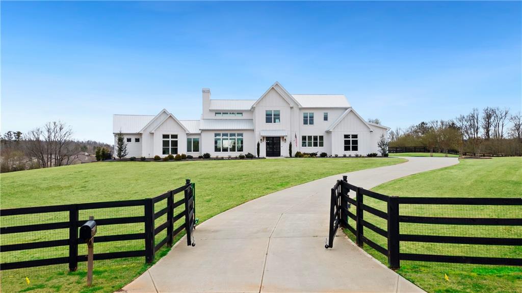 5150 Howard Road Cumming, GA 30040 - Photo 1 of 1 a front view of a house with a yard table and chairs