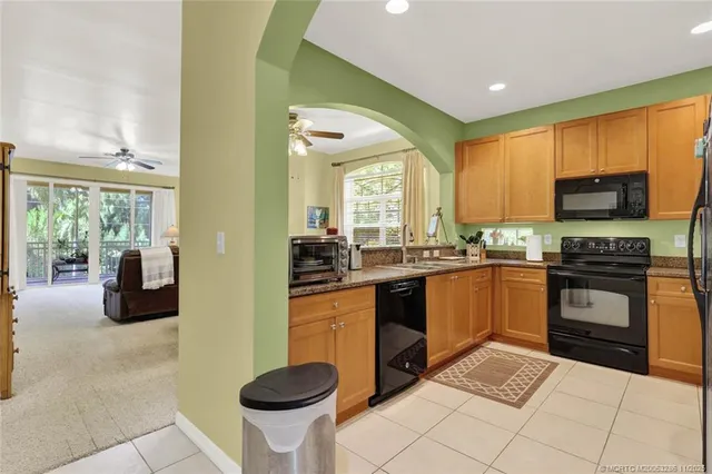 a kitchen with stainless steel appliances granite countertop a refrigerator stove and sink