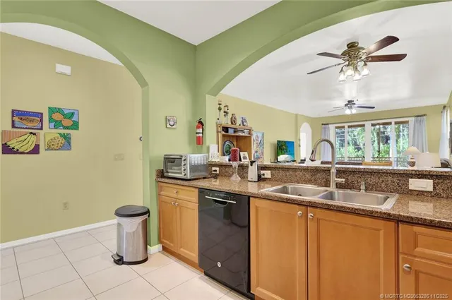 a living room with furniture a chandelier and a table
