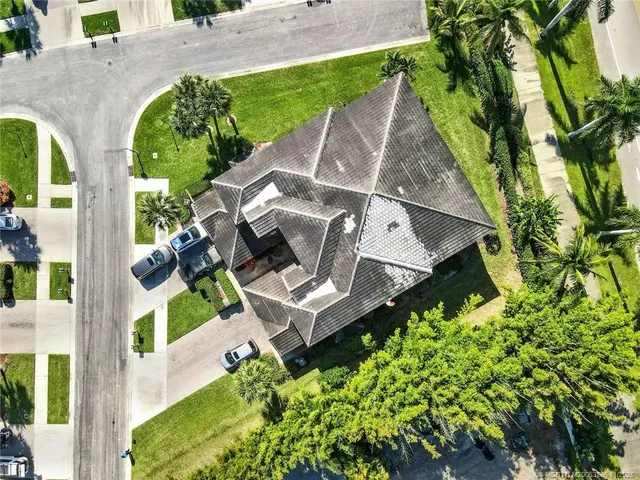 an aerial view of a house with garden space and street view