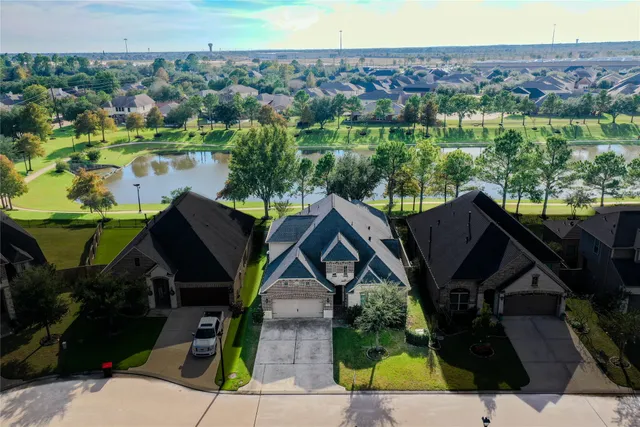 an aerial view of a house with outdoor space and street view