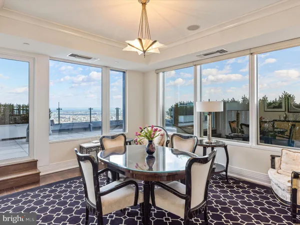 a living room with furniture a flat screen tv and a large window