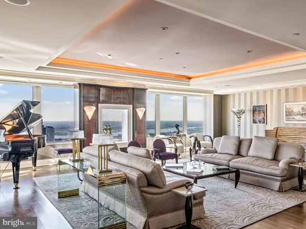 a living room with furniture and a chandelier