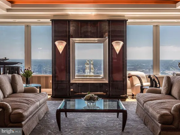 a living room with furniture a rug and a window