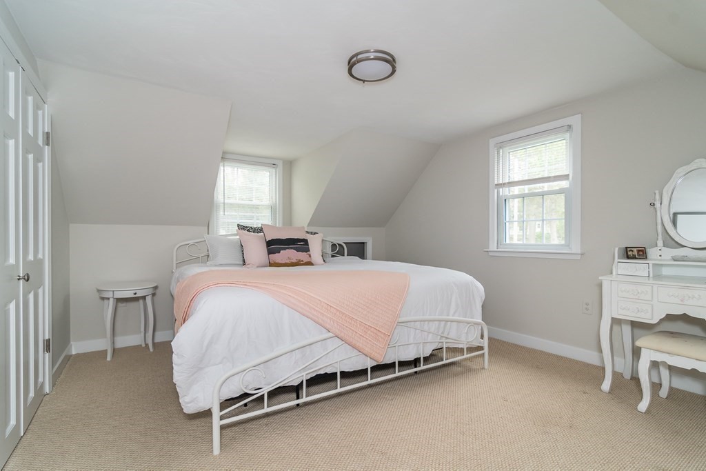 15 Nimitz Circle Natick, MA 01760 - Photo 13 of 21 a spacious bedroom with a bed a chair and next to a window