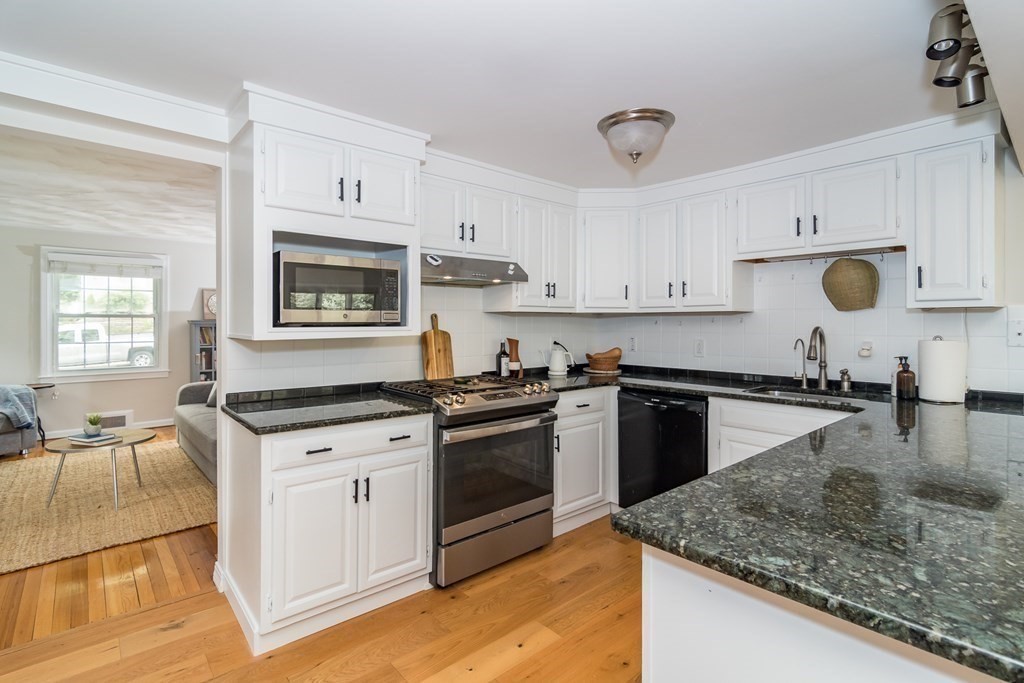 15 Nimitz Circle Natick, MA 01760 - Photo 8 of 21 a kitchen with granite countertop a stove sink and cabinets