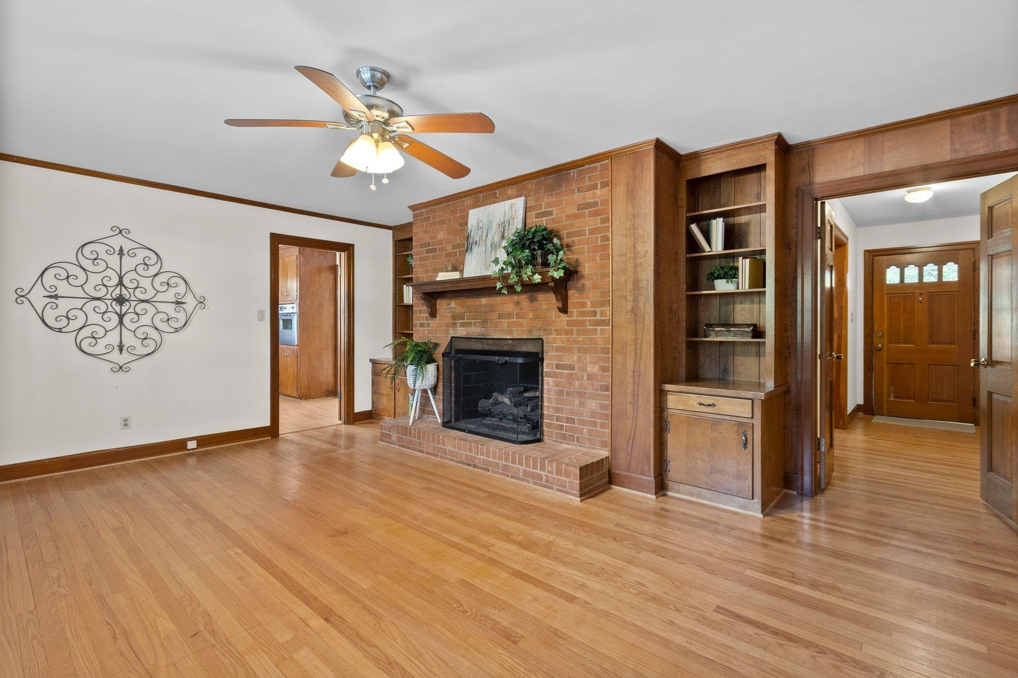 1208 Country Ridge Drive Raleigh, NC 27609 - Photo 15 of 32 Family Room features a gas log fireplace that can be wood burning and surrounding built ins. Family Room