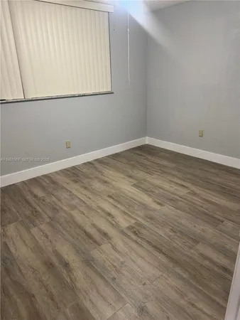 an empty room with wooden floor
