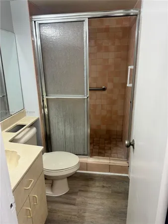 a bathroom with a shower and a toilet