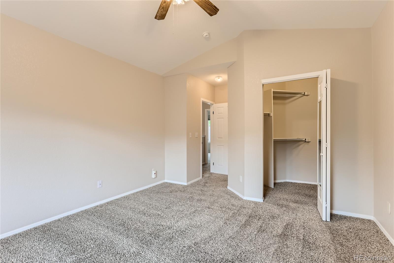 6478 Silver Mesa Drive, Unit E Highlands Ranch, CO 80130 - Photo 17 of 34 an empty room with closet and windows