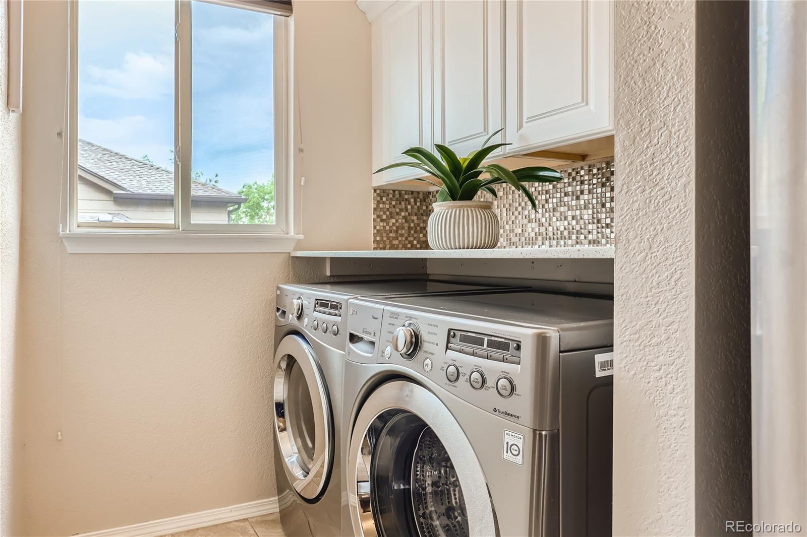 6478 Silver Mesa Drive, Unit E Highlands Ranch, CO 80130 - Photo 25 of 34 a view of washer and dryer with a window