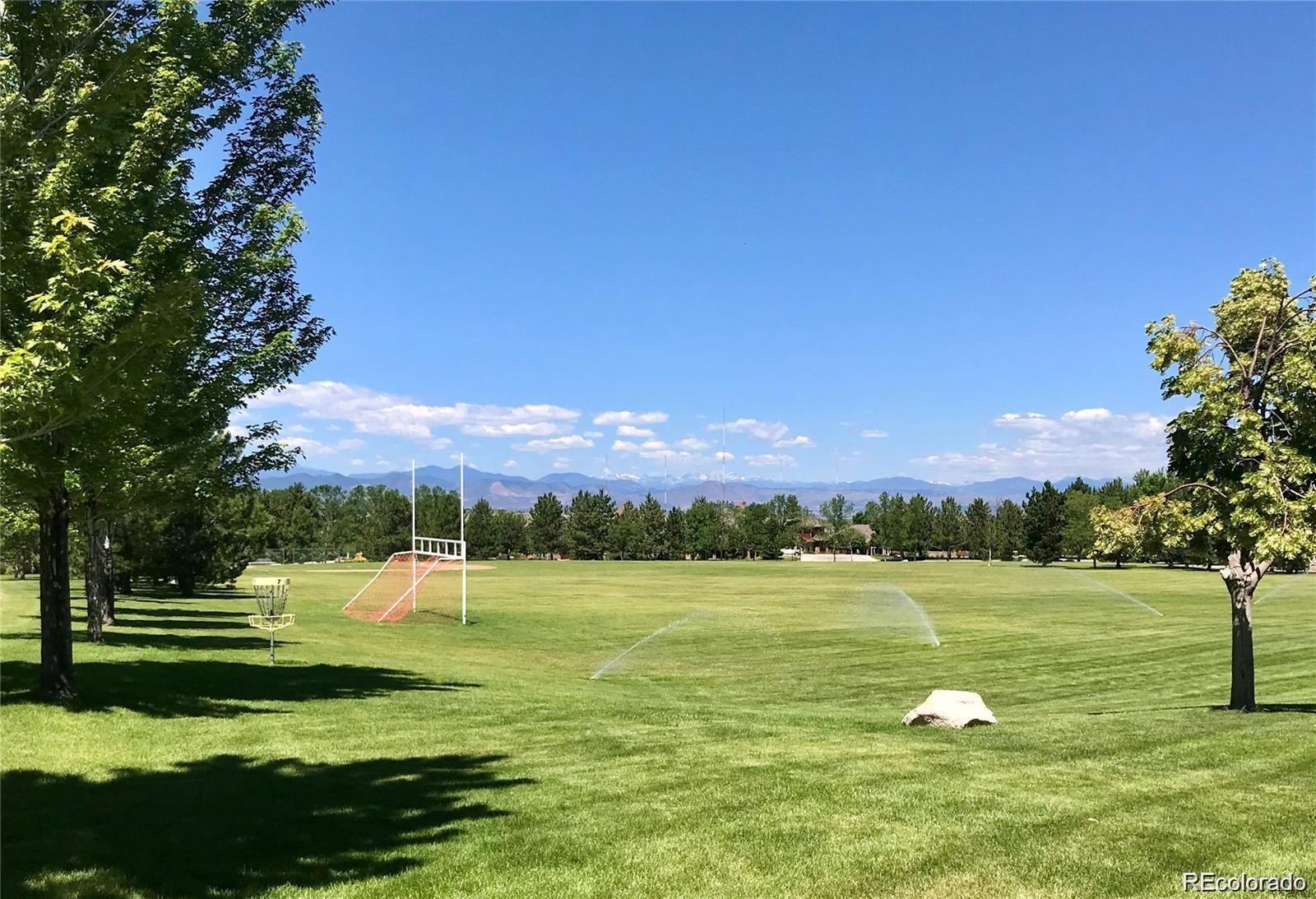 6478 Silver Mesa Drive, Unit E Highlands Ranch, CO 80130 - Photo 28 of 34 a view of a golf course with a lake