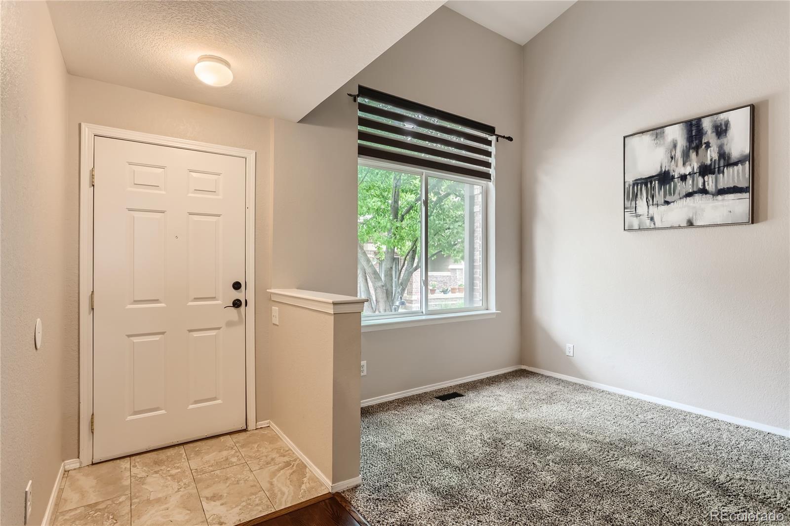6478 Silver Mesa Drive, Unit E Highlands Ranch, CO 80130 - Photo 4 of 34 an empty room with windows and closet