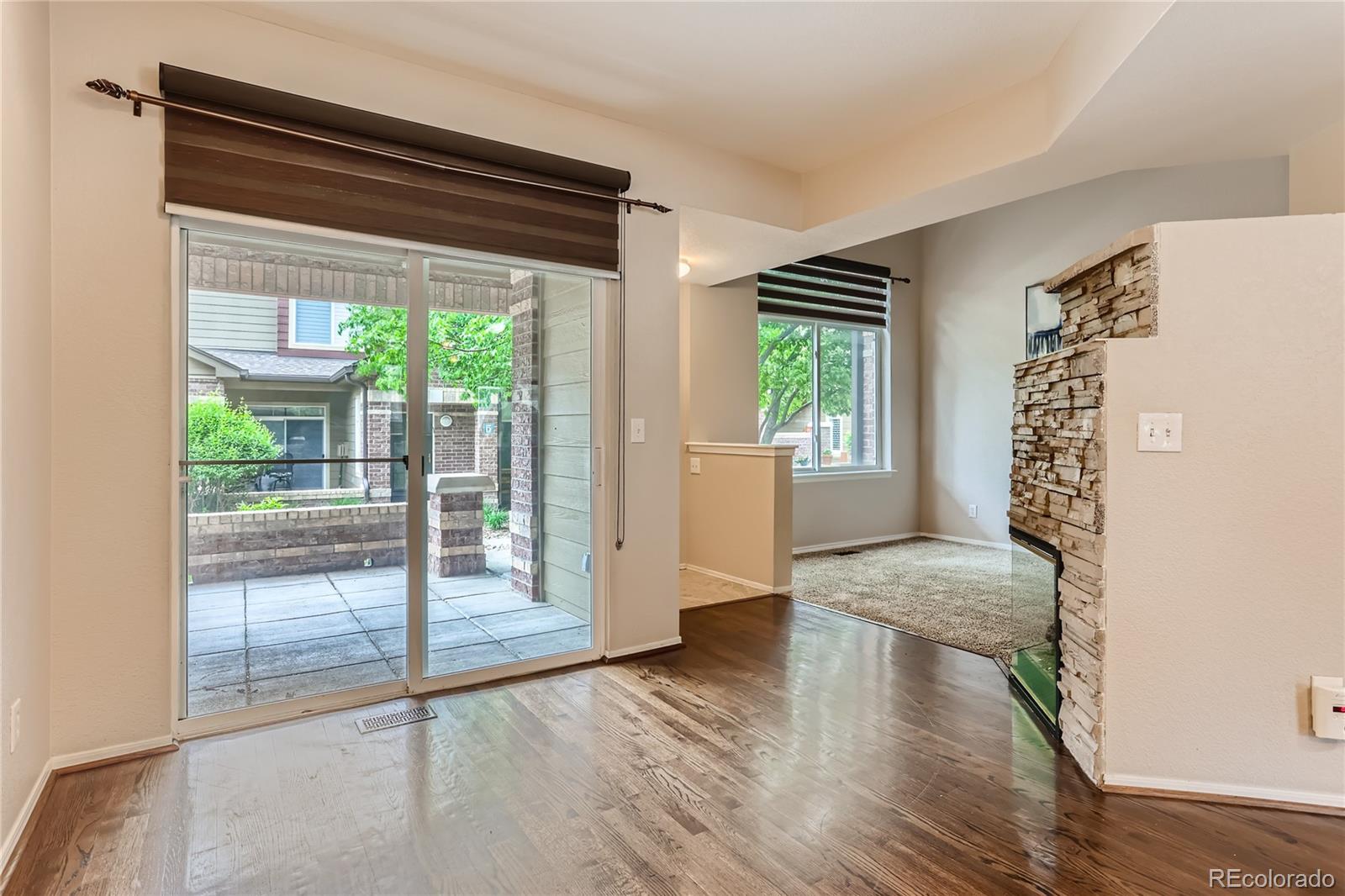 6478 Silver Mesa Drive, Unit E Highlands Ranch, CO 80130 - Photo 8 of 34 a view of empty room with wooden floor and fan