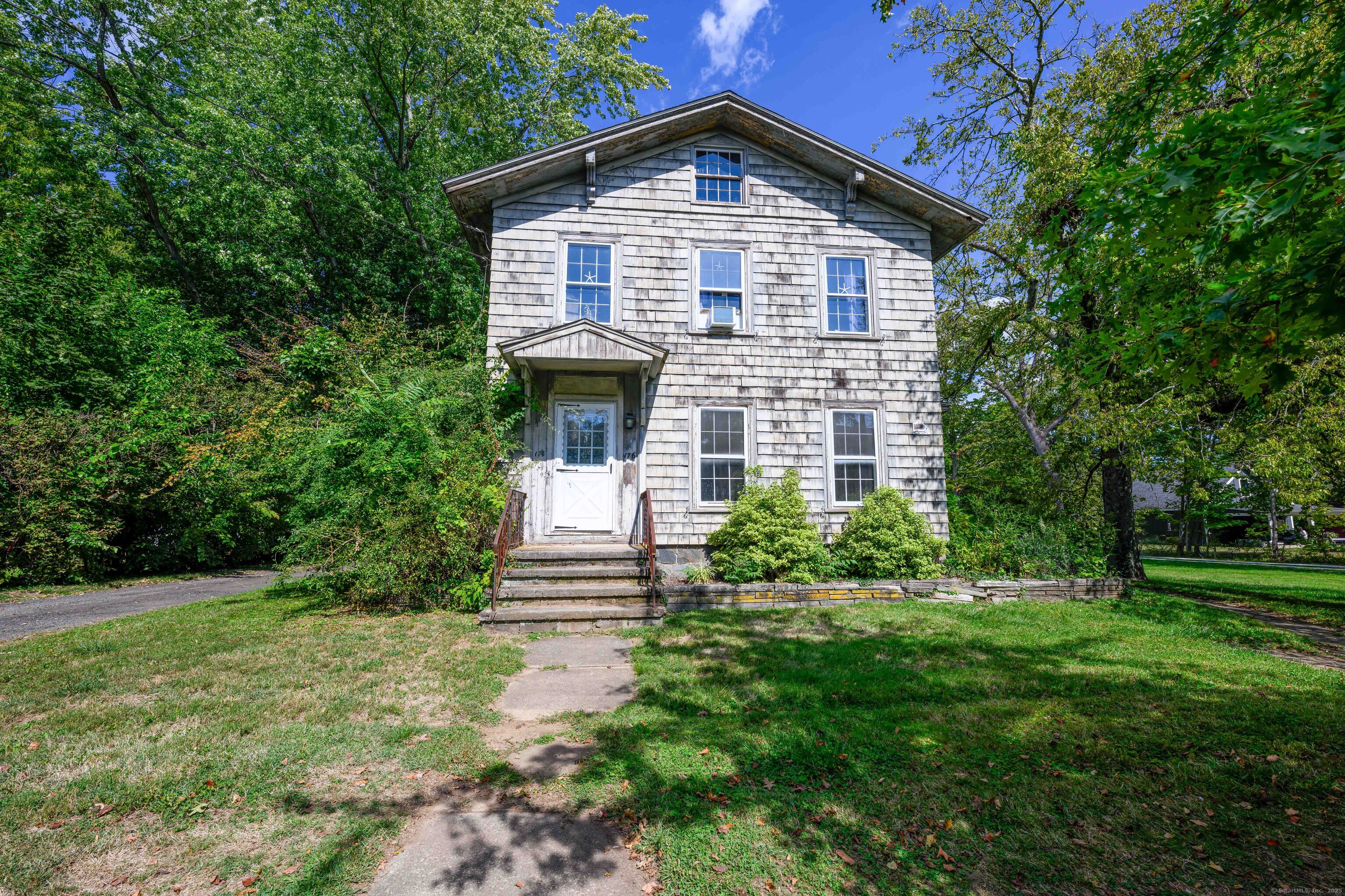 174 Whitfield Street Guilford, CT 06437 - Photo 11 of 40 a front view of a house with a yard