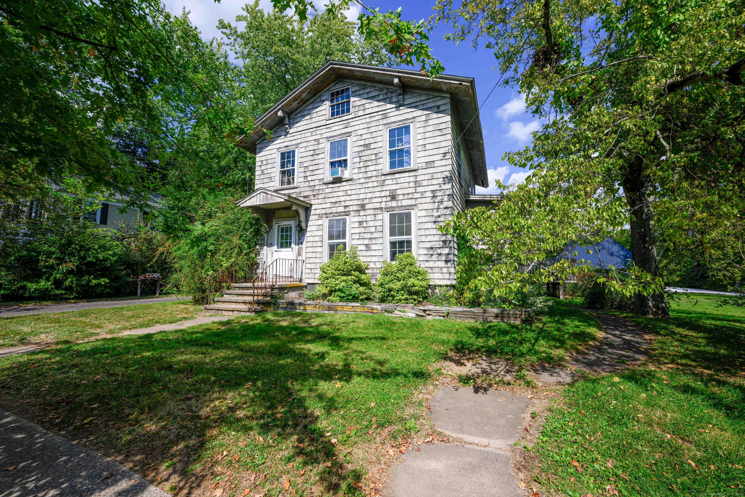 174 Whitfield Street Guilford, CT 06437 - Photo 12 of 40 a front view of a house with a yard