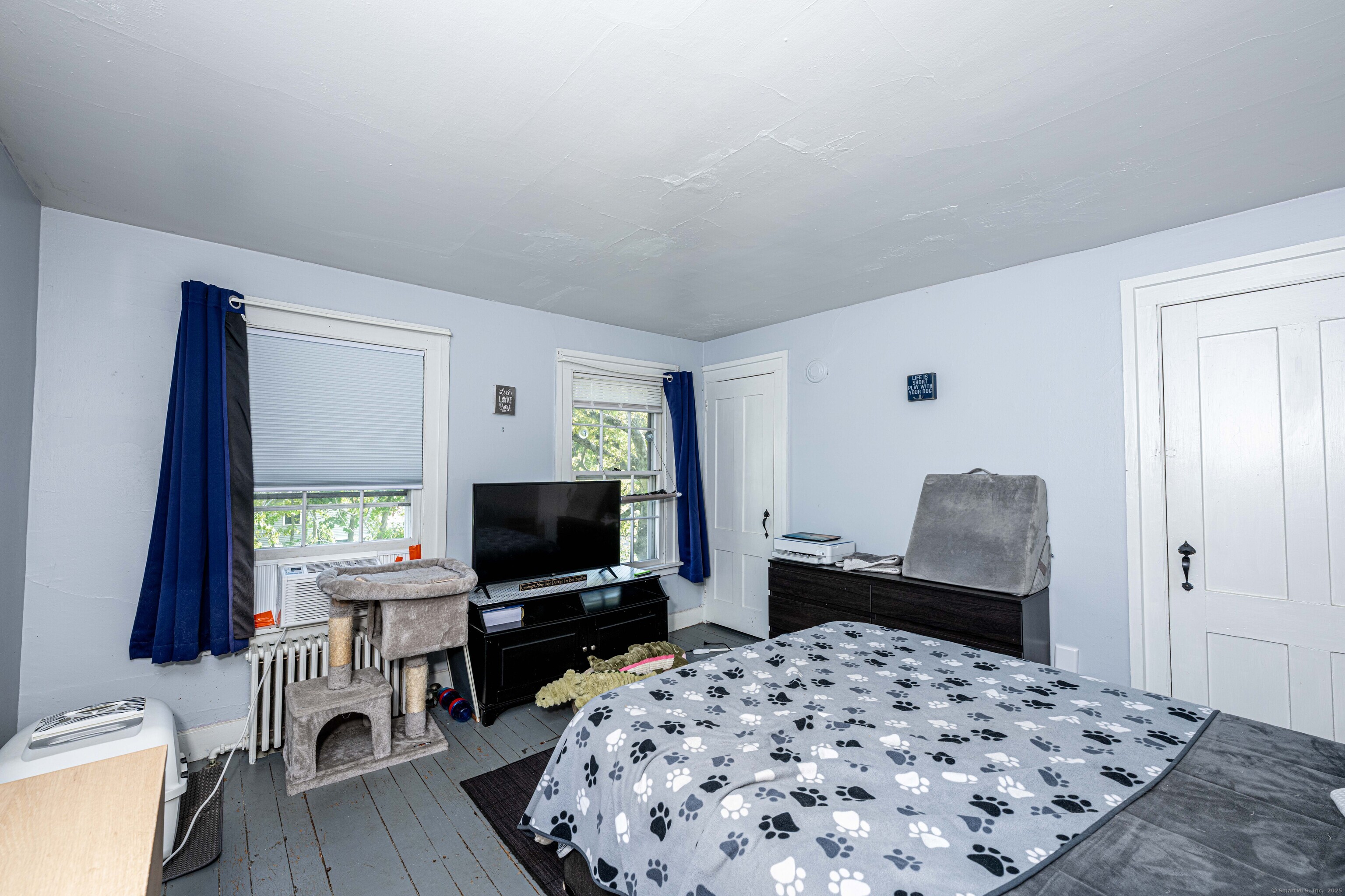 174 Whitfield Street Guilford, CT 06437 - Photo 18 of 40 a bedroom with a bed and a flat screen tv